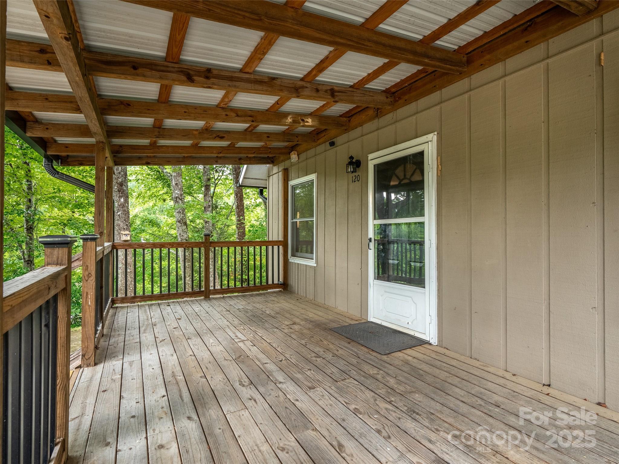 120 Wolf Pen Cove Road Brevard, NC 28712 - Photo 8 of 32 a view of a porch with wooden floor and outdoor space