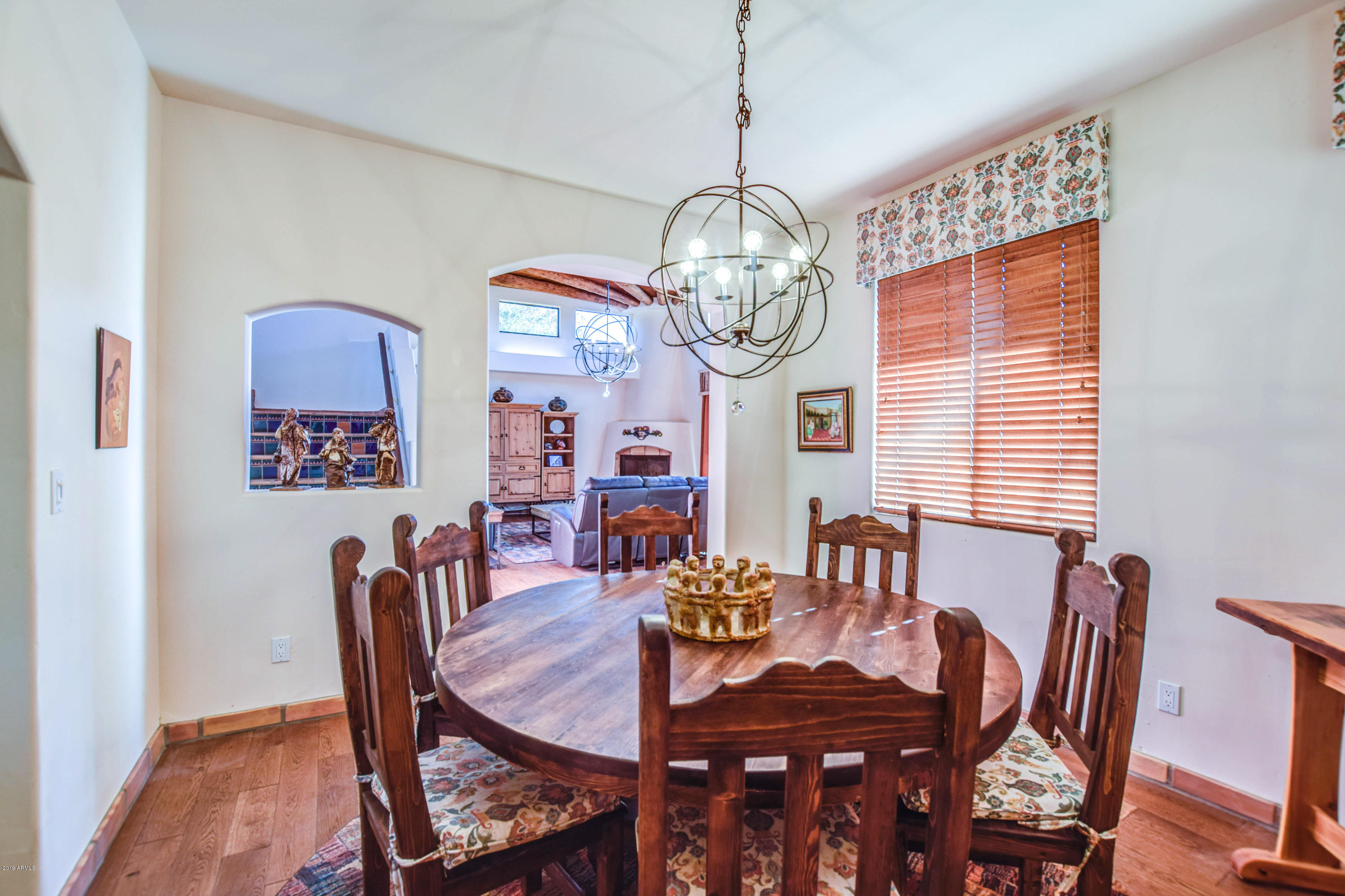 3530 North Hawes Road, Unit 10 Mesa, AZ 85207 - Photo 15 of 76 a view of a dining room with furniture a chandelier and wooden floor