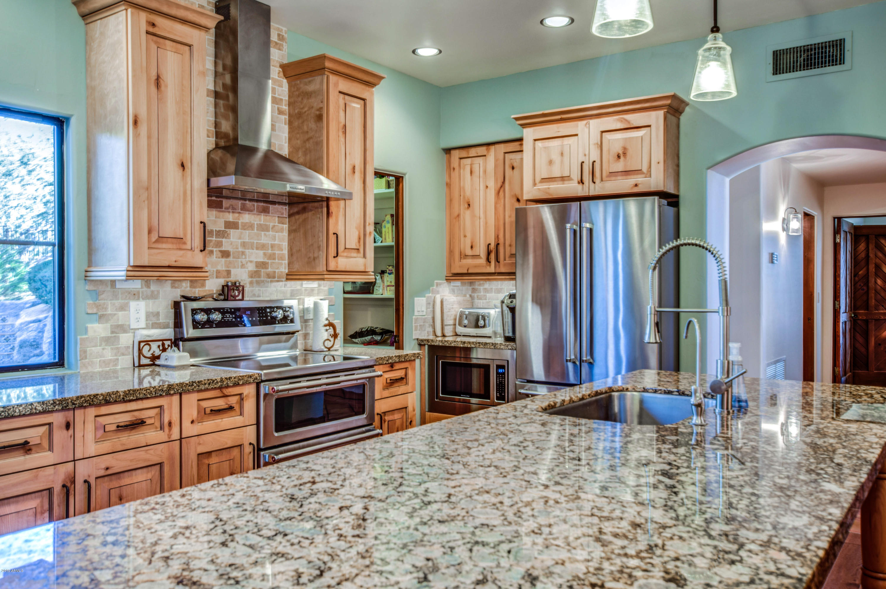 3530 North Hawes Road, Unit 10 Mesa, AZ 85207 - Photo 17 of 76 a kitchen with stainless steel appliances granite countertop a stove refrigerator and cabinets