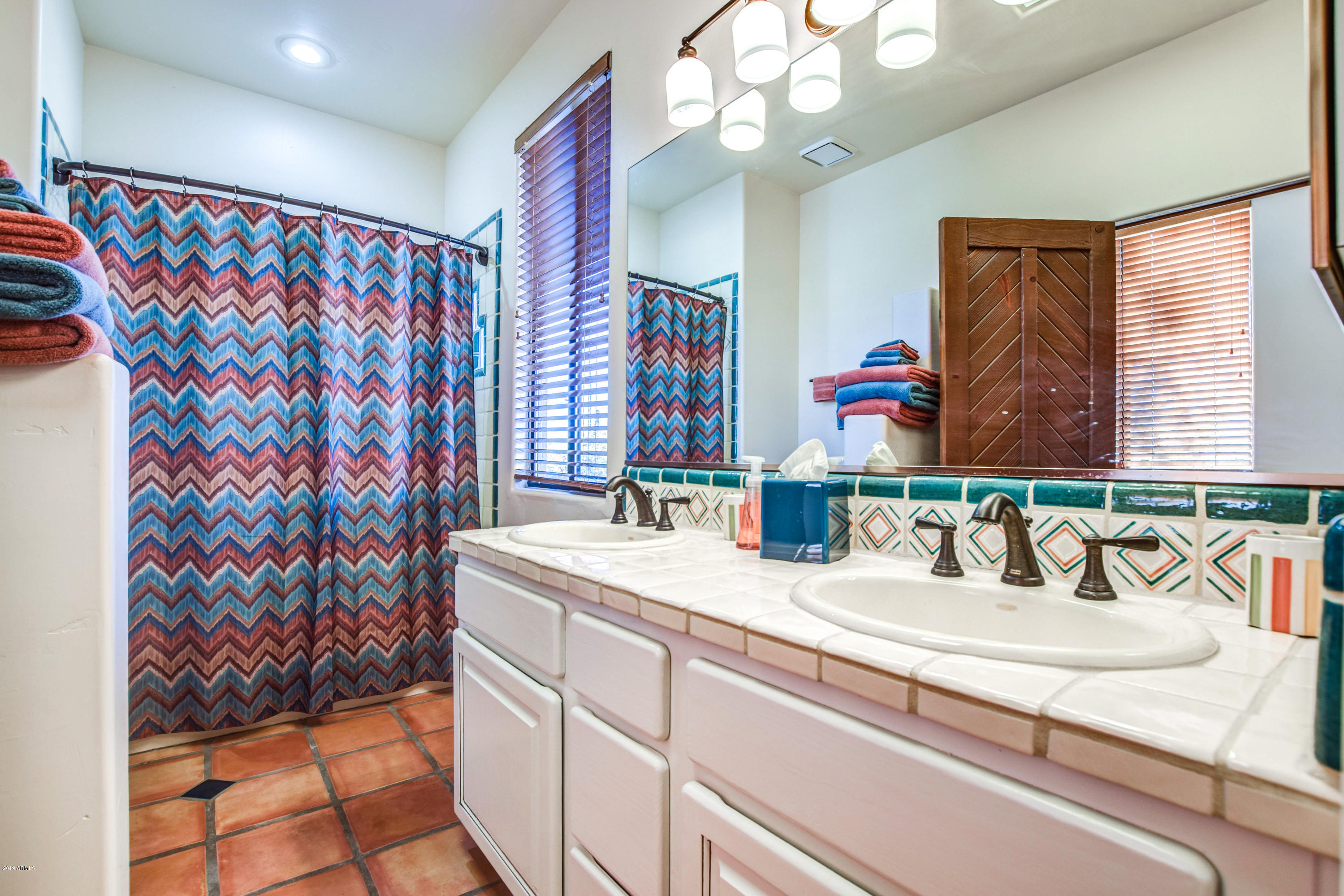 3530 North Hawes Road, Unit 10 Mesa, AZ 85207 - Photo 31 of 76 a bathroom with a sink mirror and vanity