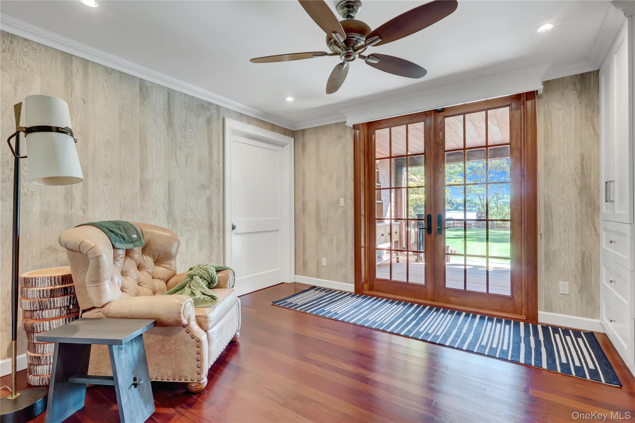 63 Dyke Road Setauket, NY 11733 - Photo 13 of 49 Living area featuring dark wood-style floors, crown molding, recessed lighting, french doors, and a ceiling fan