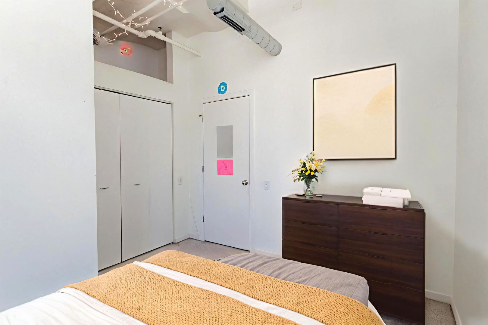 500 South Clinton Street, Unit 743 Chicago, IL 60607 - Photo 9 of 16 a bedroom with a bed and a dresser