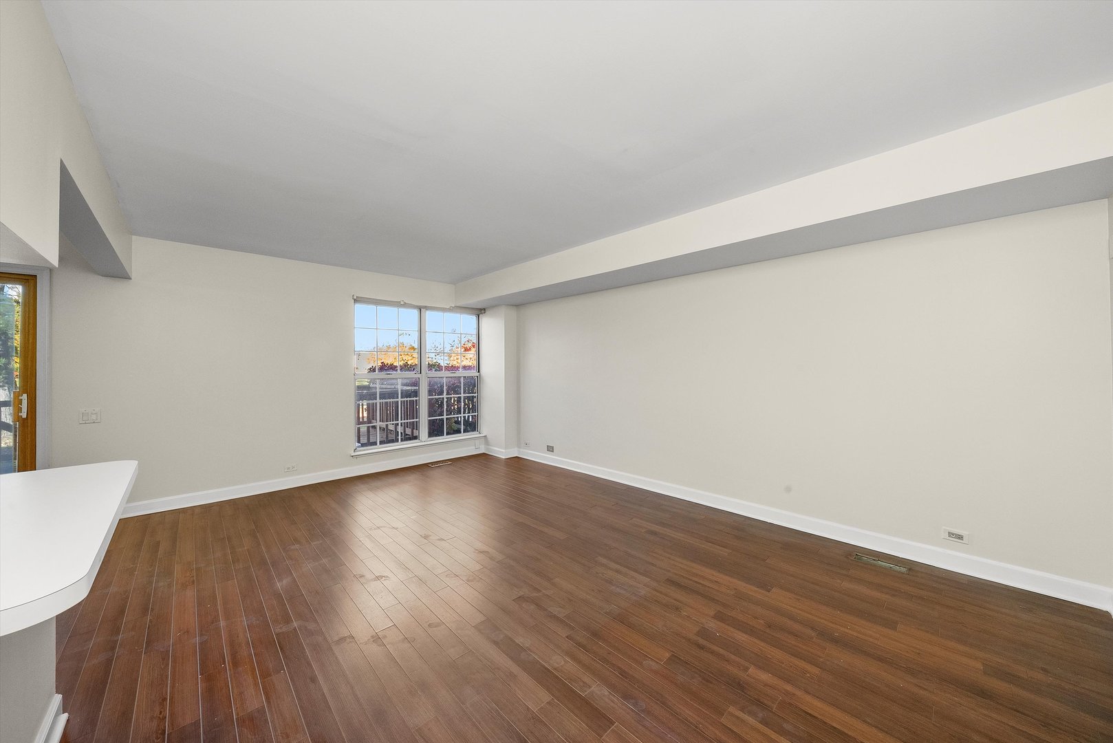 1862 Pebble Beach Circle Elgin, IL 60123 - Photo 3 of 26 a view of an empty room with wooden floor and a window