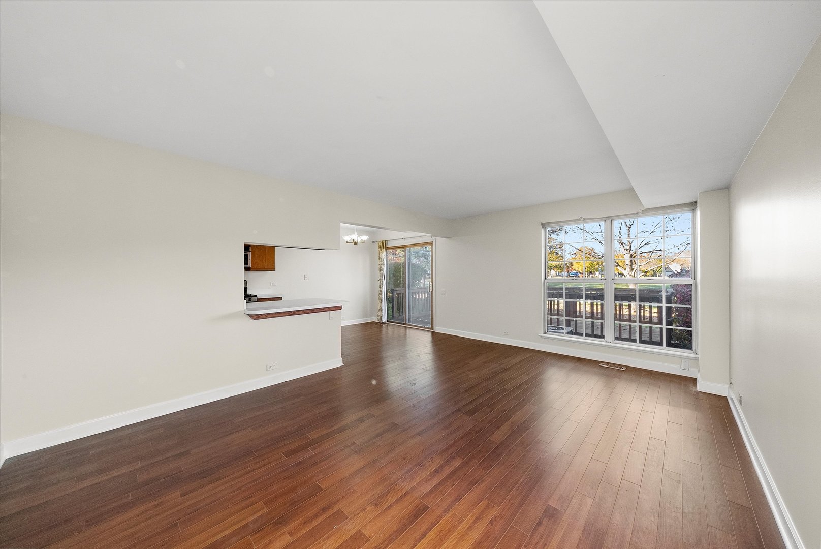 1862 Pebble Beach Circle Elgin, IL 60123 - Photo 4 of 26 an empty room with wooden floor and windows