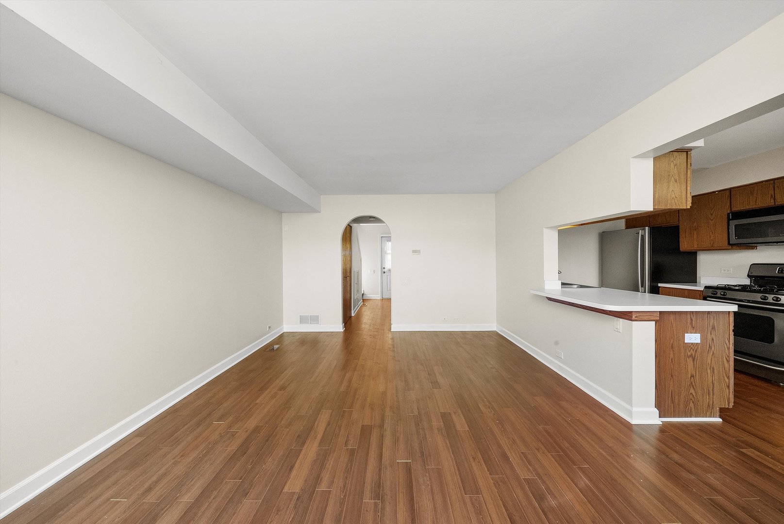 1862 Pebble Beach Circle Elgin, IL 60123 - Photo 5 of 26 a view of empty room with wooden floor and kitchen