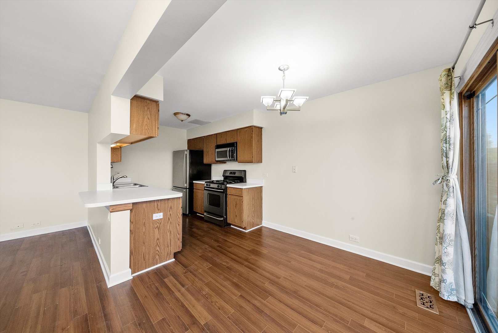 1862 Pebble Beach Circle Elgin, IL 60123 - Photo 8 of 26 a kitchen with cabinets wooden floor and stainless steel appliances