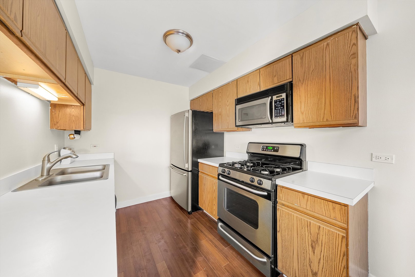 1862 Pebble Beach Circle Elgin, IL 60123 - Photo 10 of 26 a kitchen with stainless steel appliances wooden cabinets and a stove top oven
