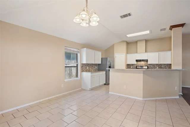a kitchen with cabinets and window