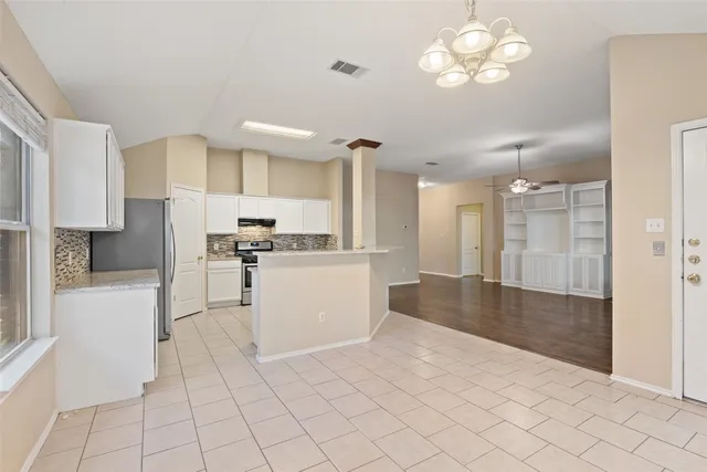 a view of kitchen with center island and stainless steel appliances
