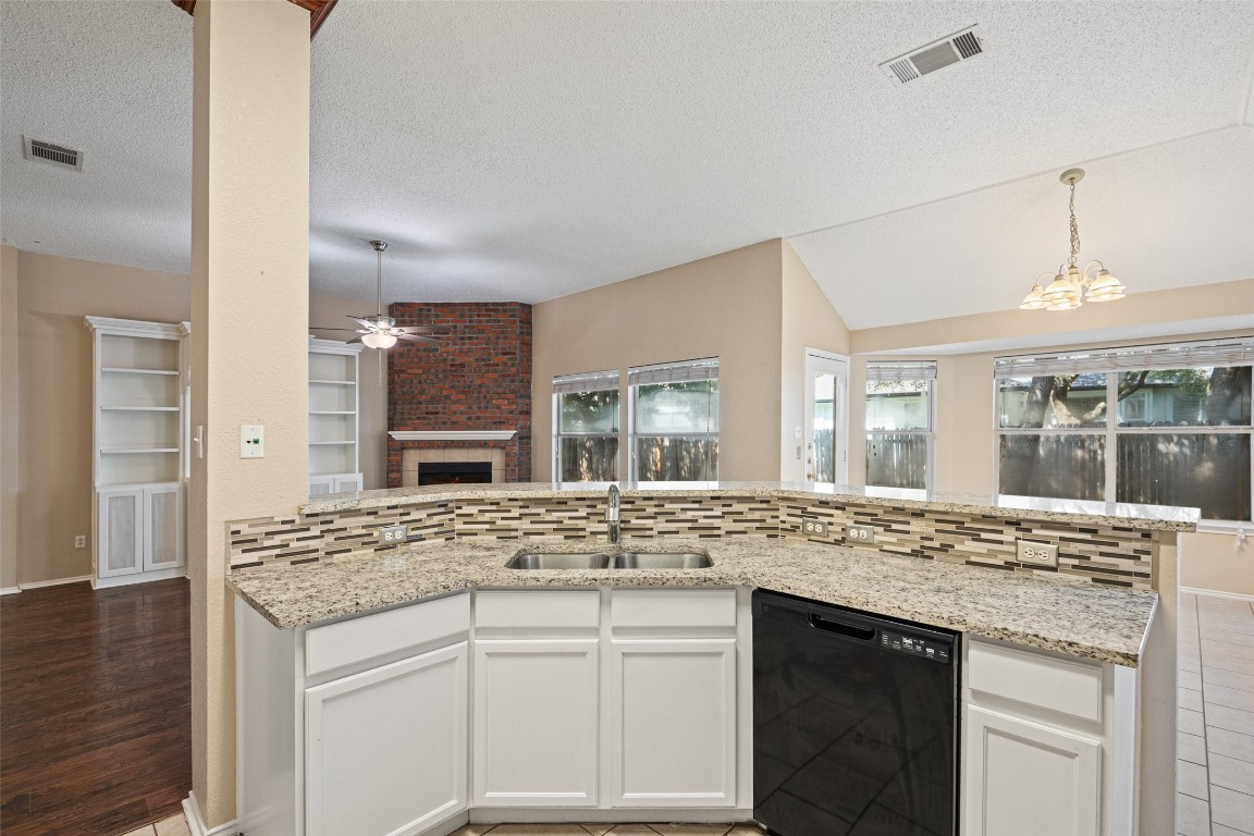 1008 Chippewa Round Rock, TX 78665 - Photo 16 of 36 a view of living room with granite countertop furniture and fireplace