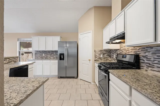 a kitchen with a stove a sink and a refrigerator