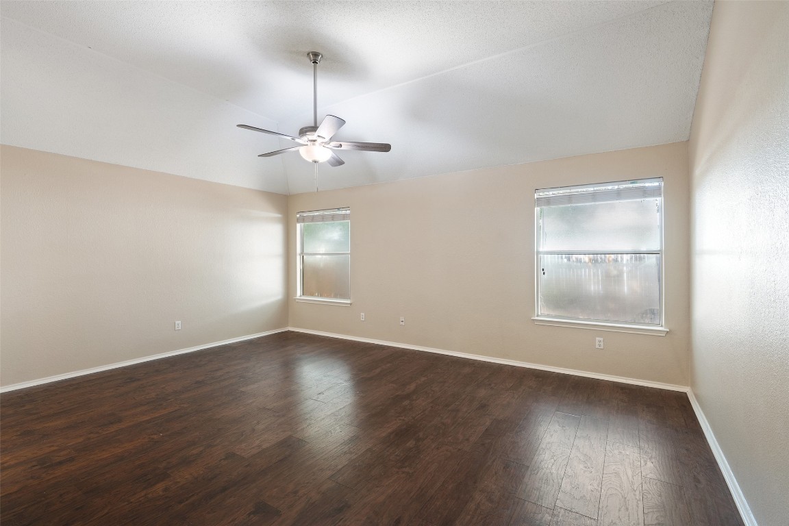 1008 Chippewa Round Rock, TX 78665 - Photo 20 of 36 an empty room with wooden floor chandelier fan and windows