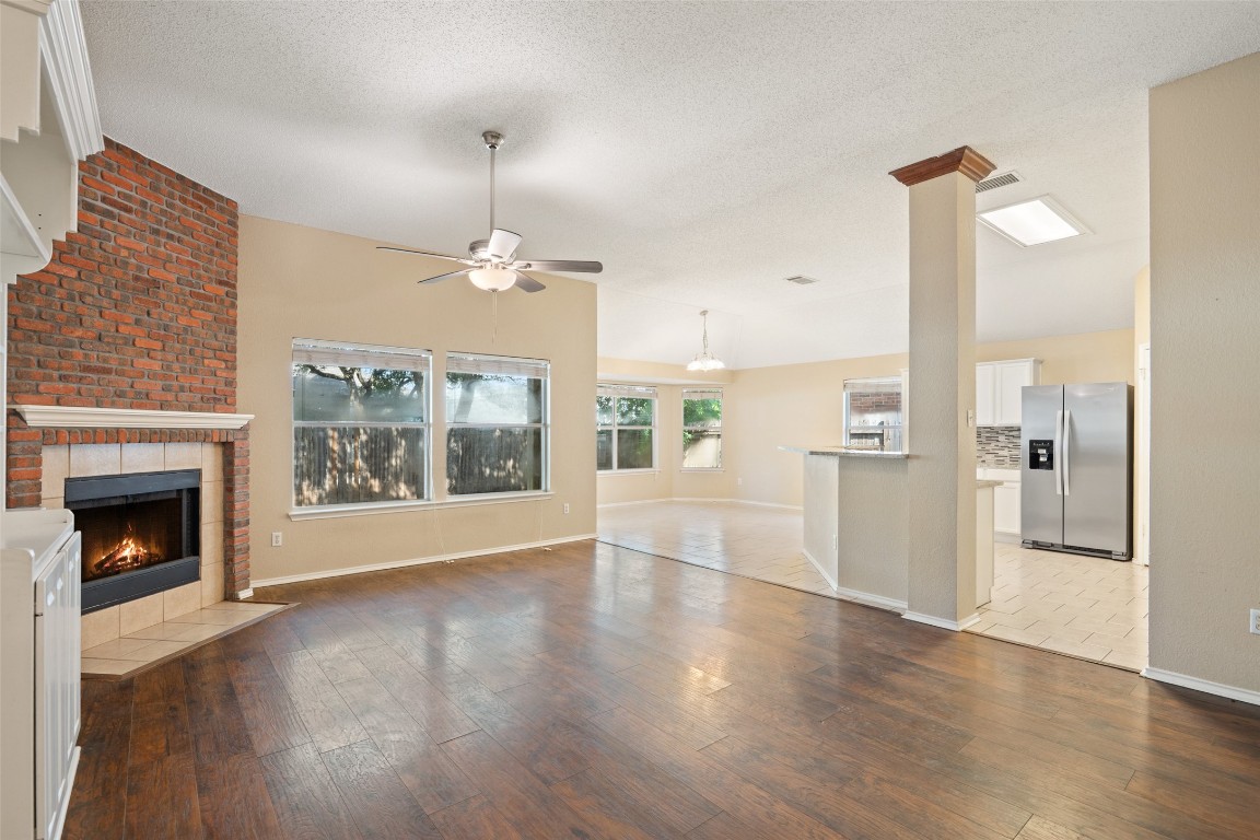 1008 Chippewa Round Rock, TX 78665 - Photo 2 of 36 a view of an empty room with wooden floor fireplace and a window