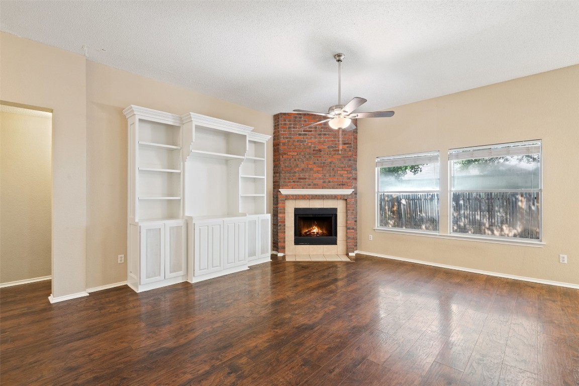1008 Chippewa Round Rock, TX 78665 - Photo 8 of 36 a view of an empty room with wooden floor fireplace and a window