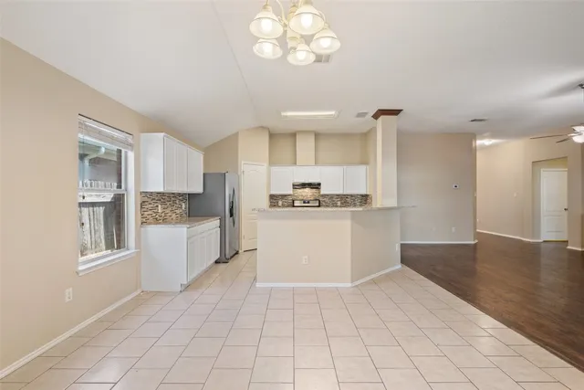 a kitchen with stainless steel appliances a refrigerator and a stove top oven