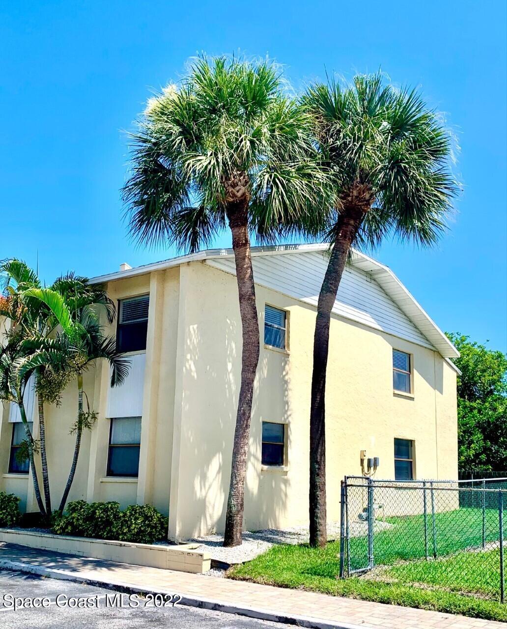 584 North Wickham Road, Unit 82 Melbourne, FL 32935 - Photo 2 of 43 a front view of a house with garden and plants