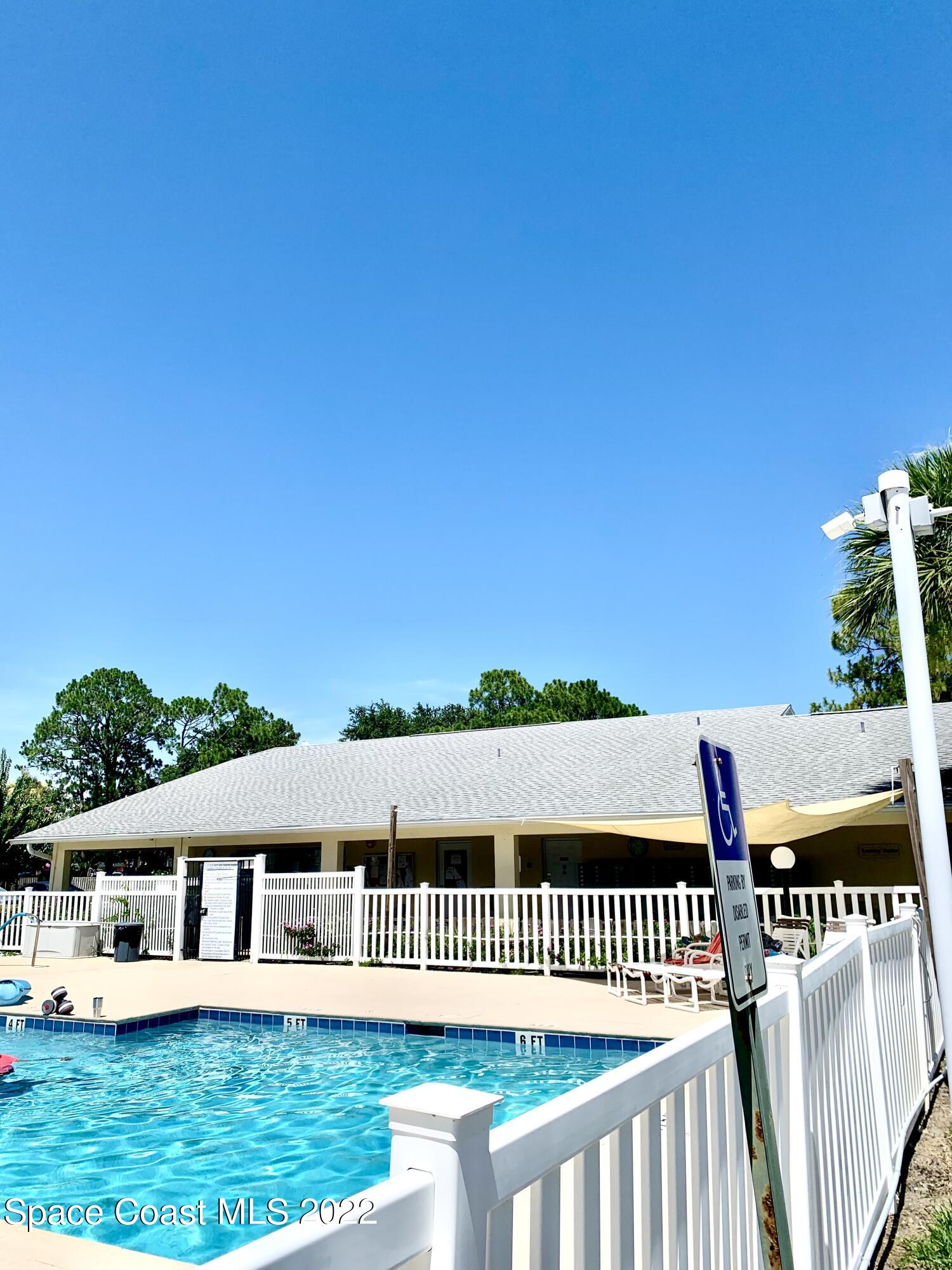 584 North Wickham Road, Unit 82 Melbourne, FL 32935 - Photo 22 of 43 a view of a house with a yard