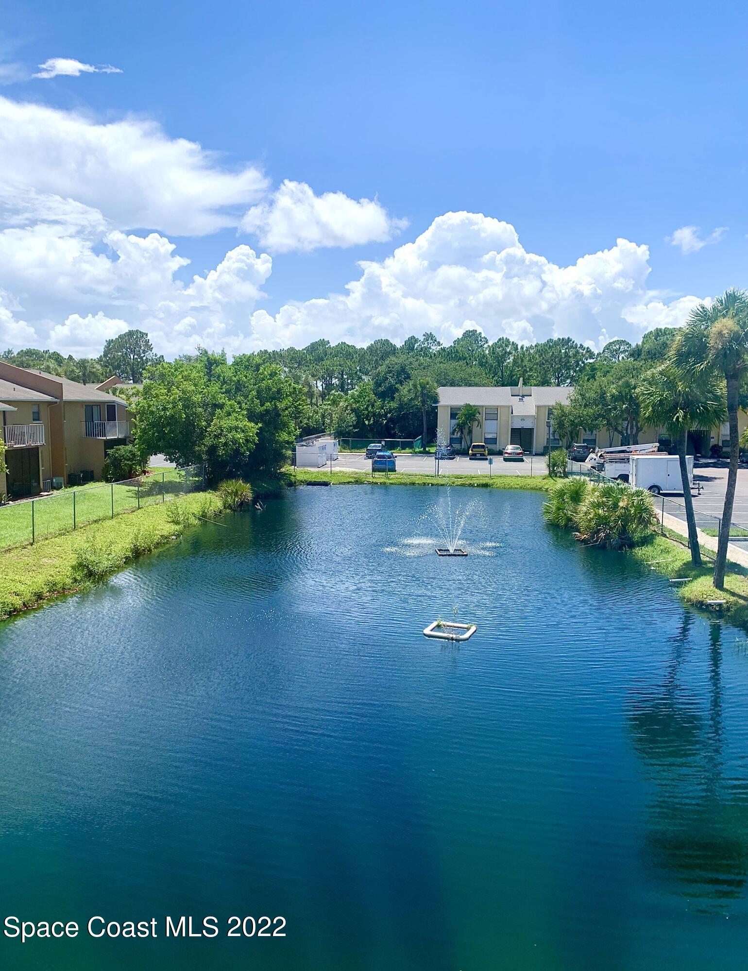 584 North Wickham Road, Unit 82 Melbourne, FL 32935 - Photo 4 of 43 a view of a lake with houses