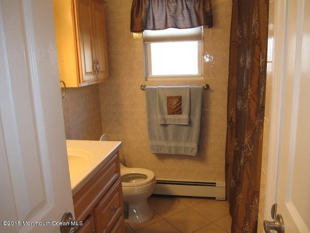 8 Bunkerhill Road Hazlet, NJ 07730 - Photo 11 of 22 a bathroom with a toilet window and mirror