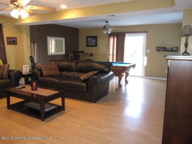 8 Bunkerhill Road Hazlet, NJ 07730 - Photo 14 of 22 a living room with furniture and a chandelier