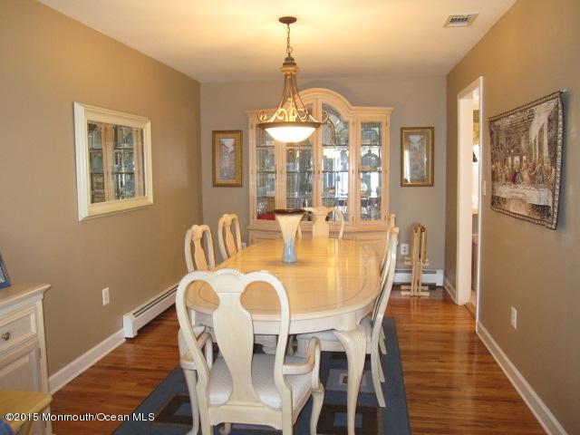 8 Bunkerhill Road Hazlet, NJ 07730 - Photo 4 of 22 a dining room with furniture a chandelier and wooden floor