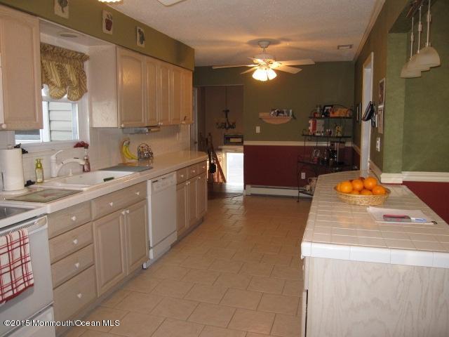 8 Bunkerhill Road Hazlet, NJ 07730 - Photo 5 of 22 a kitchen with a sink stove and cabinets