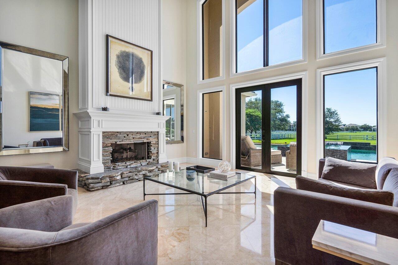 9891 Equus Circle Boynton Beach, FL 33472 - Photo 15 of 88 a living room with furniture large window and a fireplace