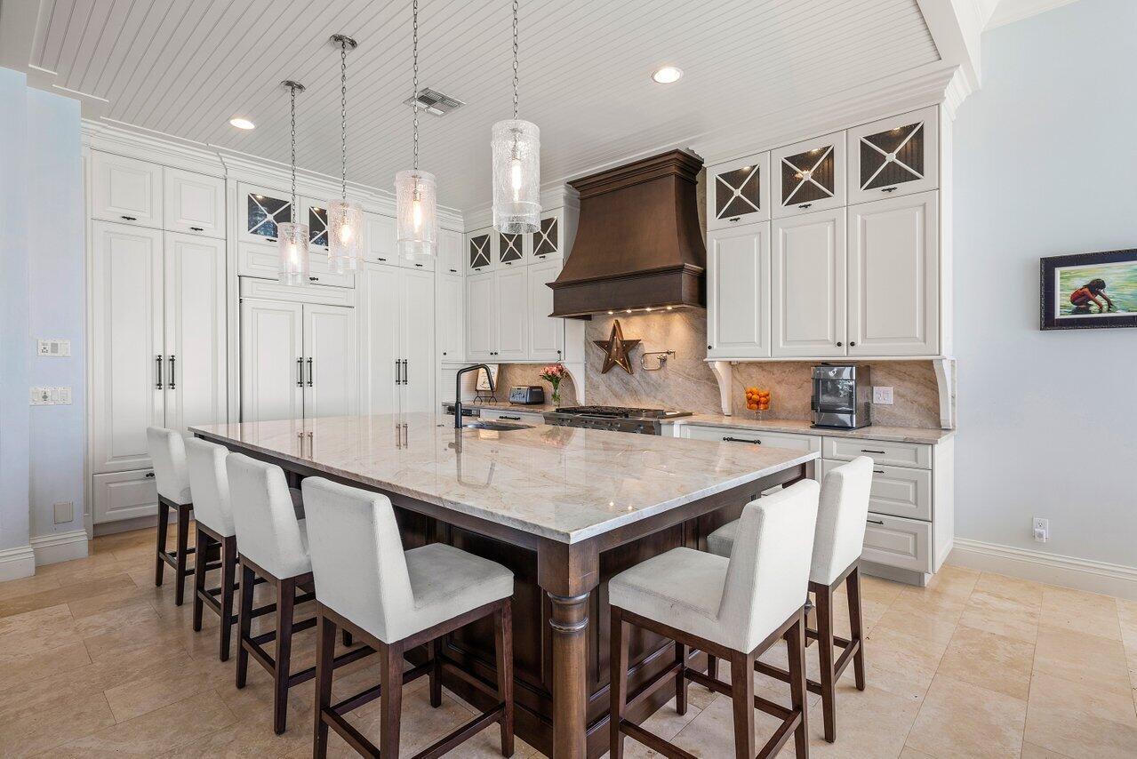 9891 Equus Circle Boynton Beach, FL 33472 - Photo 21 of 88 a kitchen with granite countertop a sink and chairs