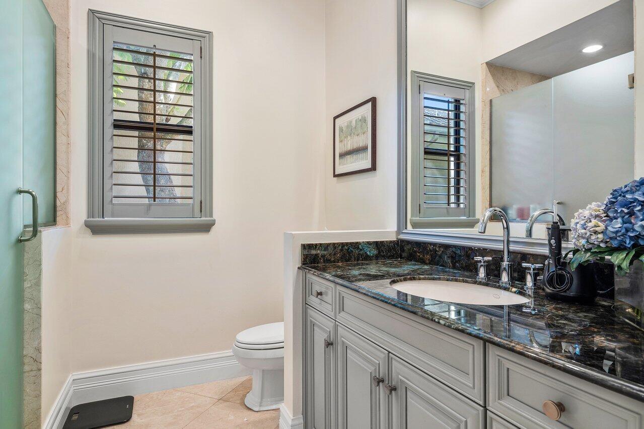 9891 Equus Circle Boynton Beach, FL 33472 - Photo 32 of 88 a bathroom with a granite countertop sink toilet and mirror