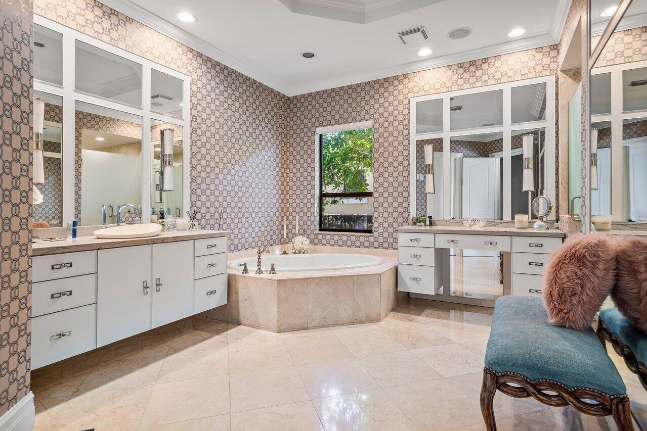 9891 Equus Circle Boynton Beach, FL 33472 - Photo 42 of 88 a spacious bathroom with a double vanity sink a large mirror and a bathtub