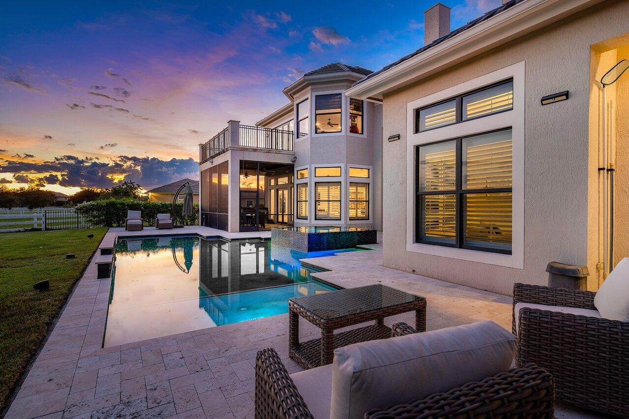 9891 Equus Circle Boynton Beach, FL 33472 - Photo 66 of 88 a backyard of a house with lake view and a potted plant