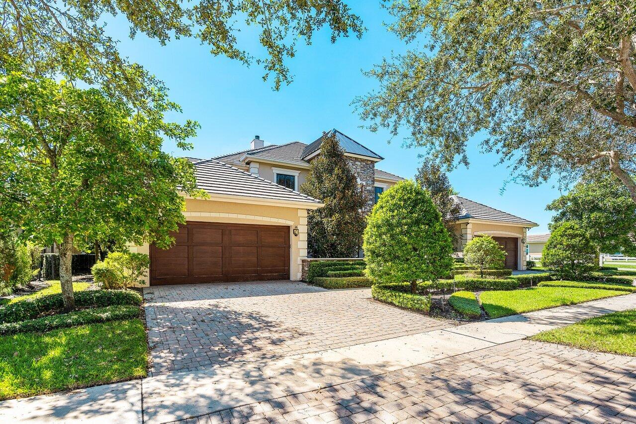 9891 Equus Circle Boynton Beach, FL 33472 - Photo 7 of 88 a front view of a house with a yard and garage