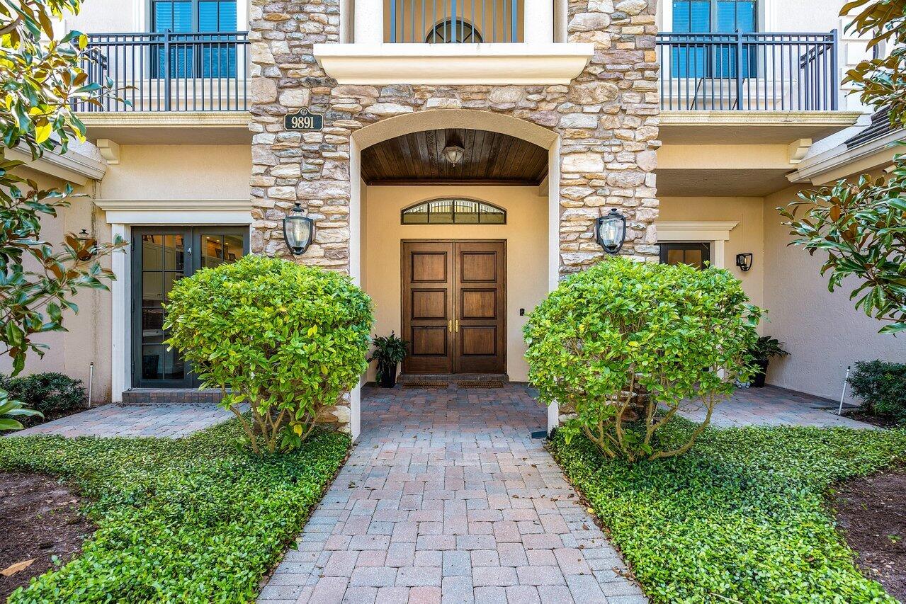 9891 Equus Circle Boynton Beach, FL 33472 - Photo 8 of 88 a front view of a house with garden and plants