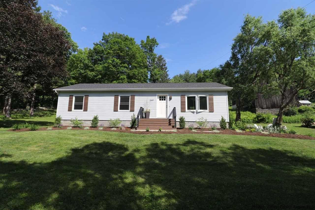 a front view of a house with a garden