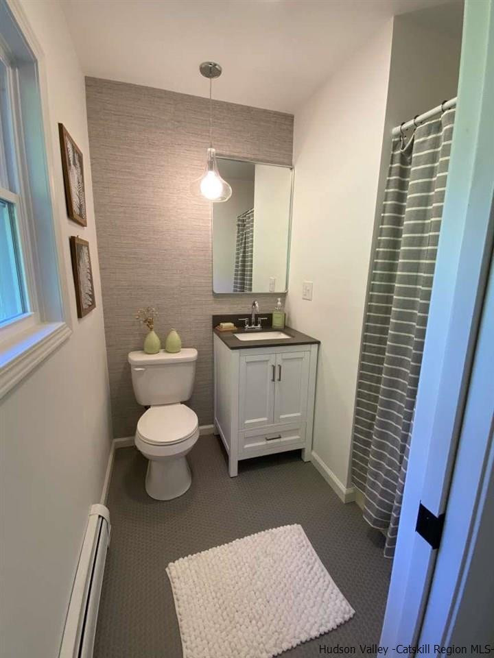 349 Co Road, Unit KRUMVILLE DAVIS CORNER RD Olivebridge, NY 12461 - Photo 16 of 25 a bathroom with a toilet a sink and a mirror