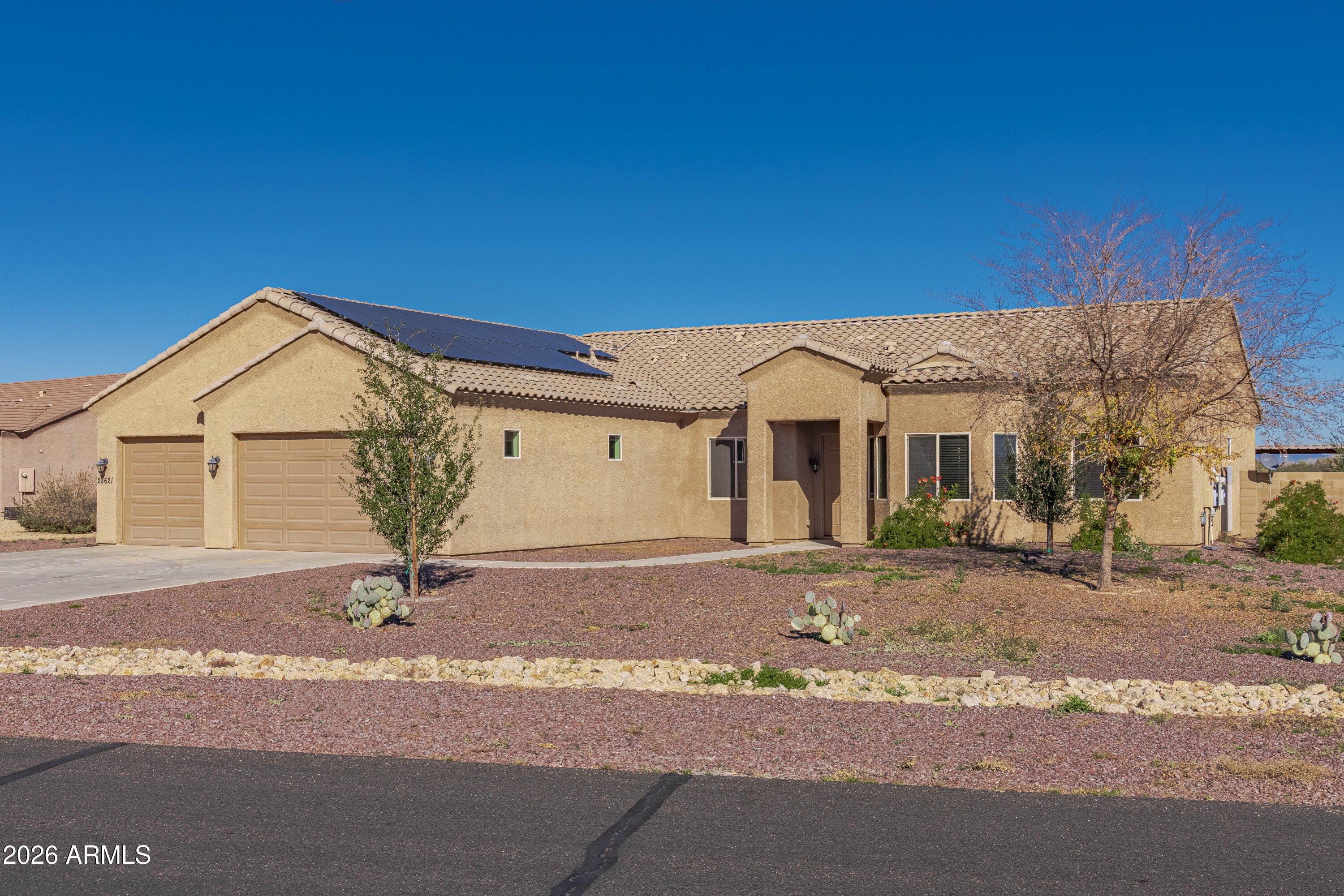 28621 North Bush Street Wittmann, AZ 85361 - Photo 15 of 41 a front view of a house with a yard and garage