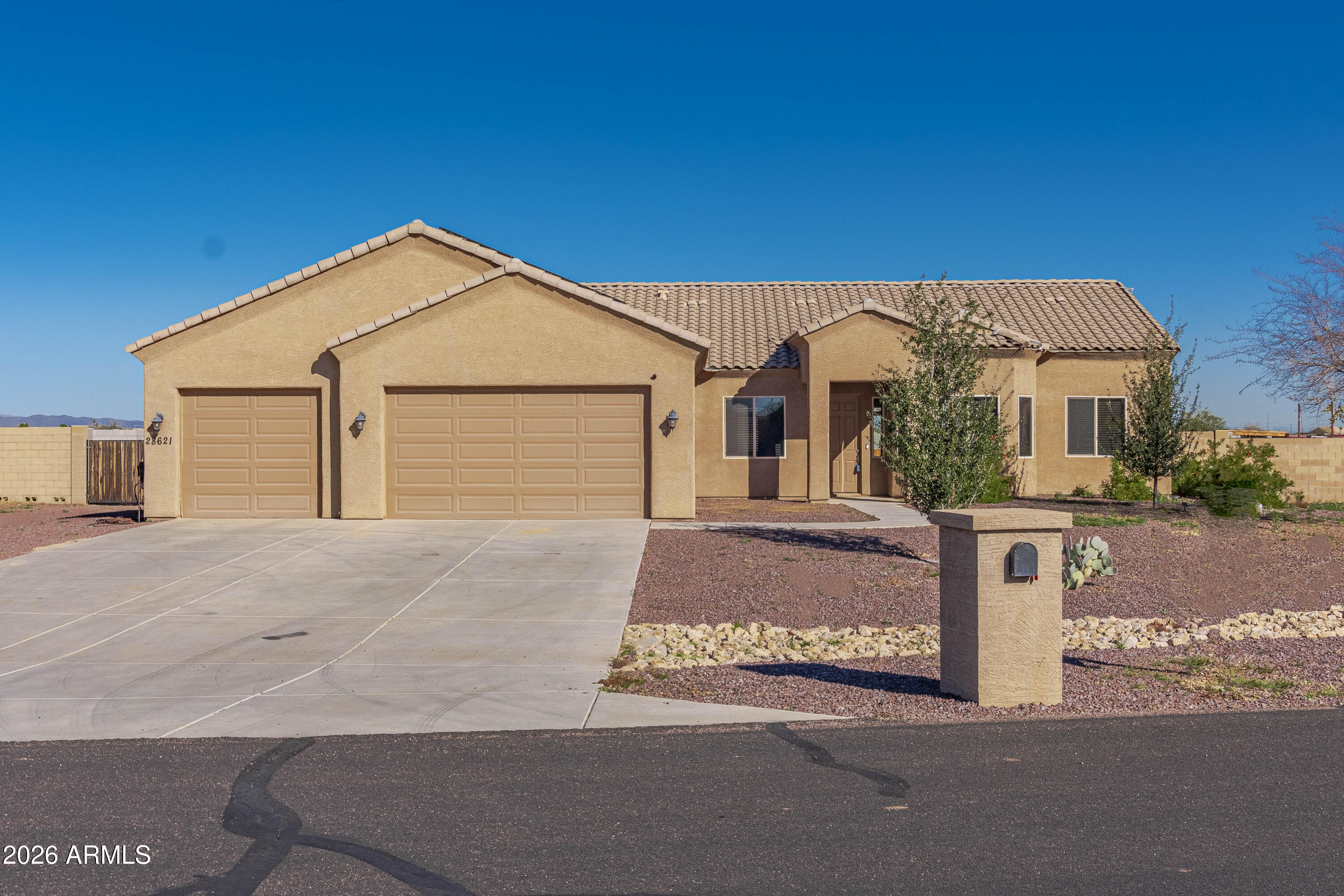 28621 North Bush Street Wittmann, AZ 85361 - Photo 16 of 41 a front view of a house with a yard and garage