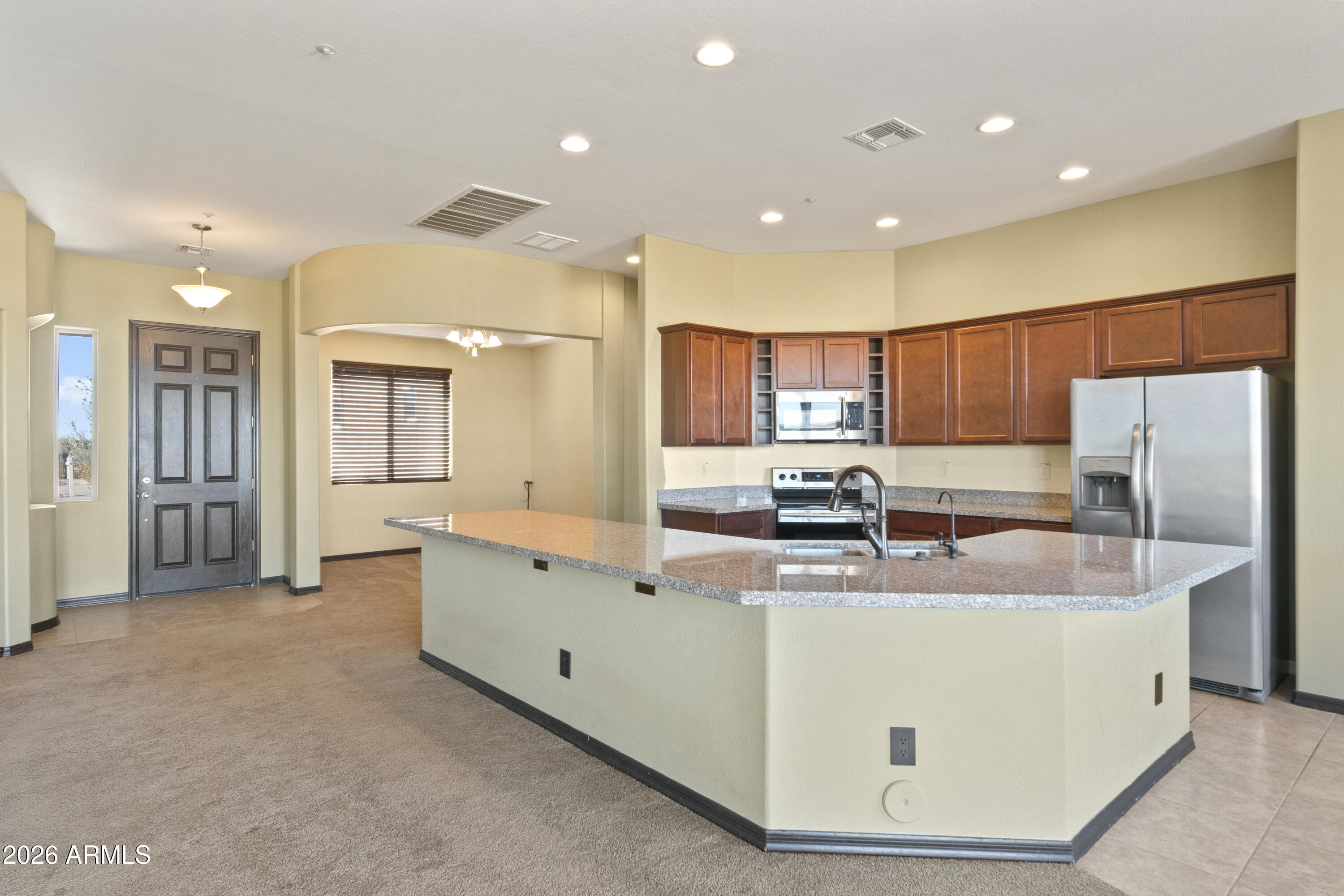 28621 North Bush Street Wittmann, AZ 85361 - Photo 21 of 41 a view of kitchen with stainless steel appliances granite countertop refrigerator sink and cabinets