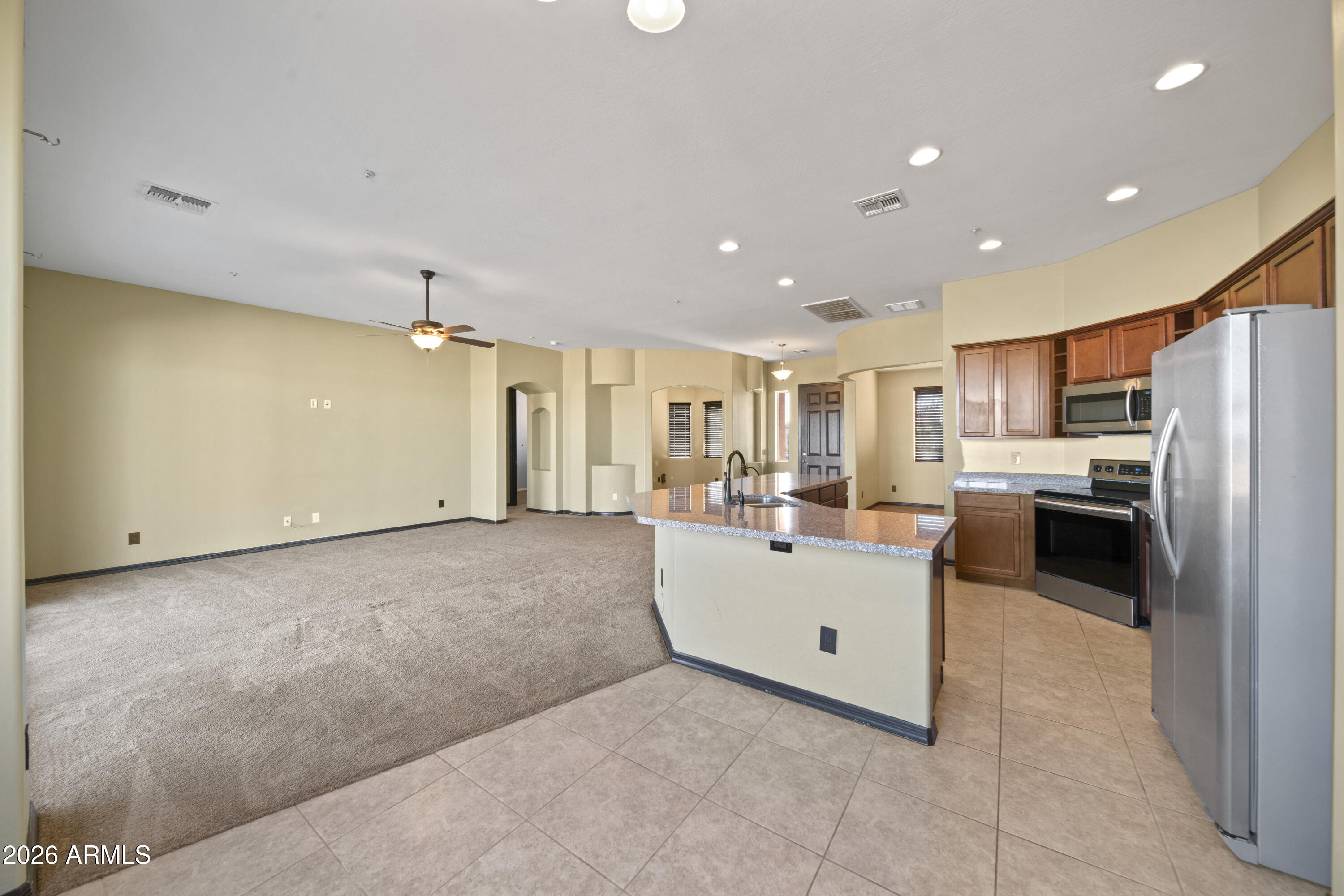 28621 North Bush Street Wittmann, AZ 85361 - Photo 22 of 41 a large white kitchen with a large window and stainless steel appliances