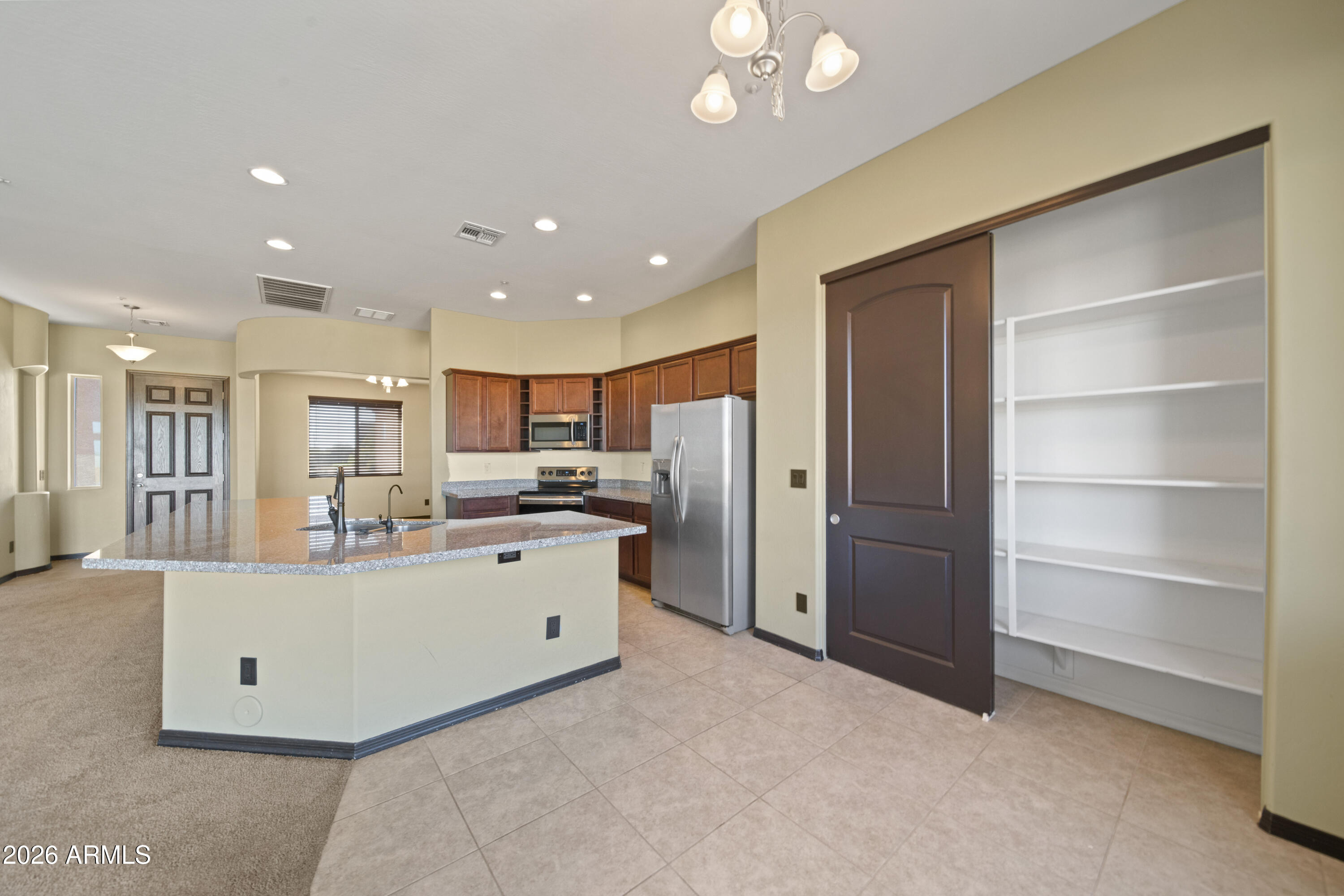 28621 North Bush Street Wittmann, AZ 85361 - Photo 24 of 41 a living room with stainless steel appliances kitchen island furniture and a kitchen view