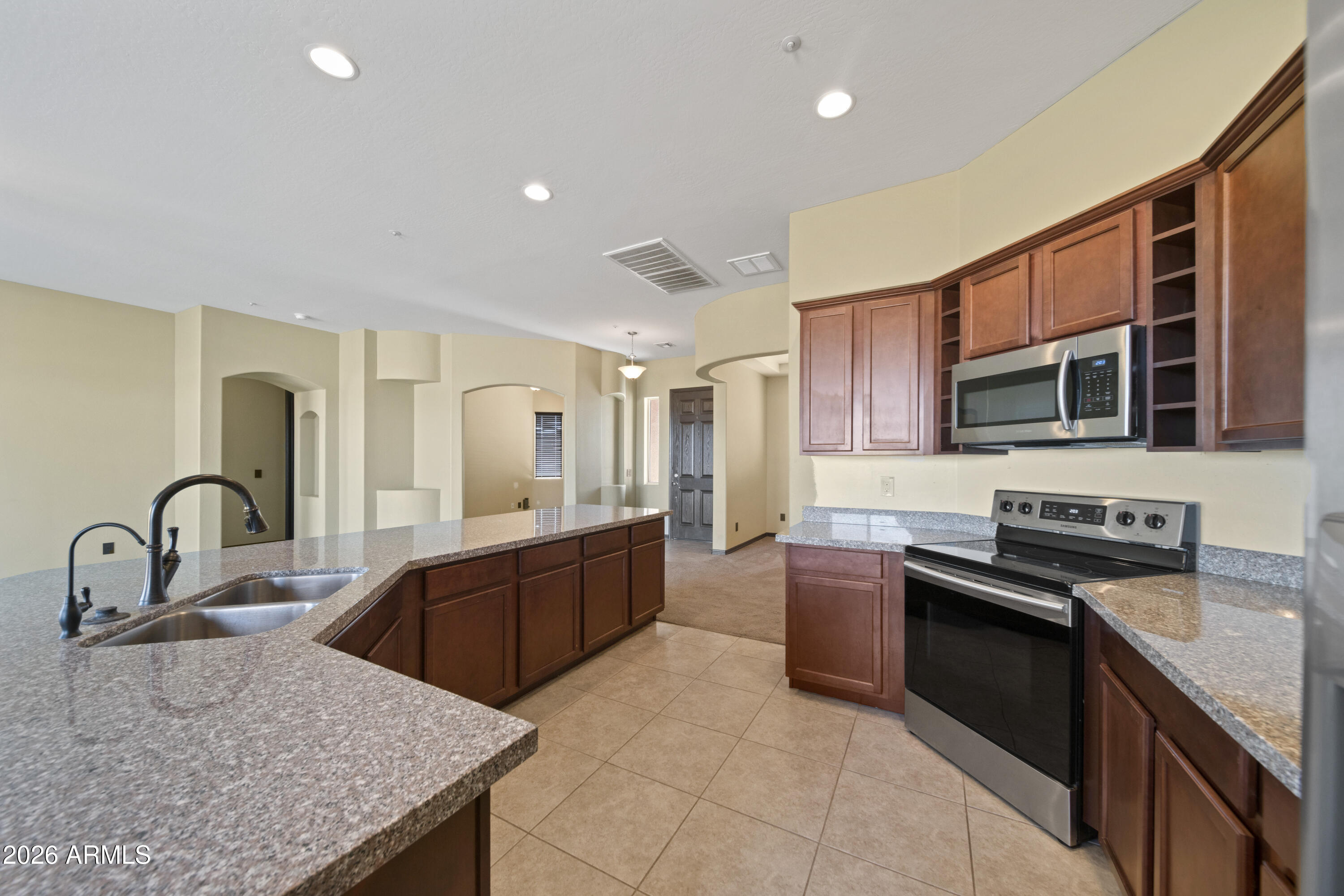 28621 North Bush Street Wittmann, AZ 85361 - Photo 27 of 41 a kitchen with stainless steel appliances granite countertop a sink a stove top oven a counter space and cabinets