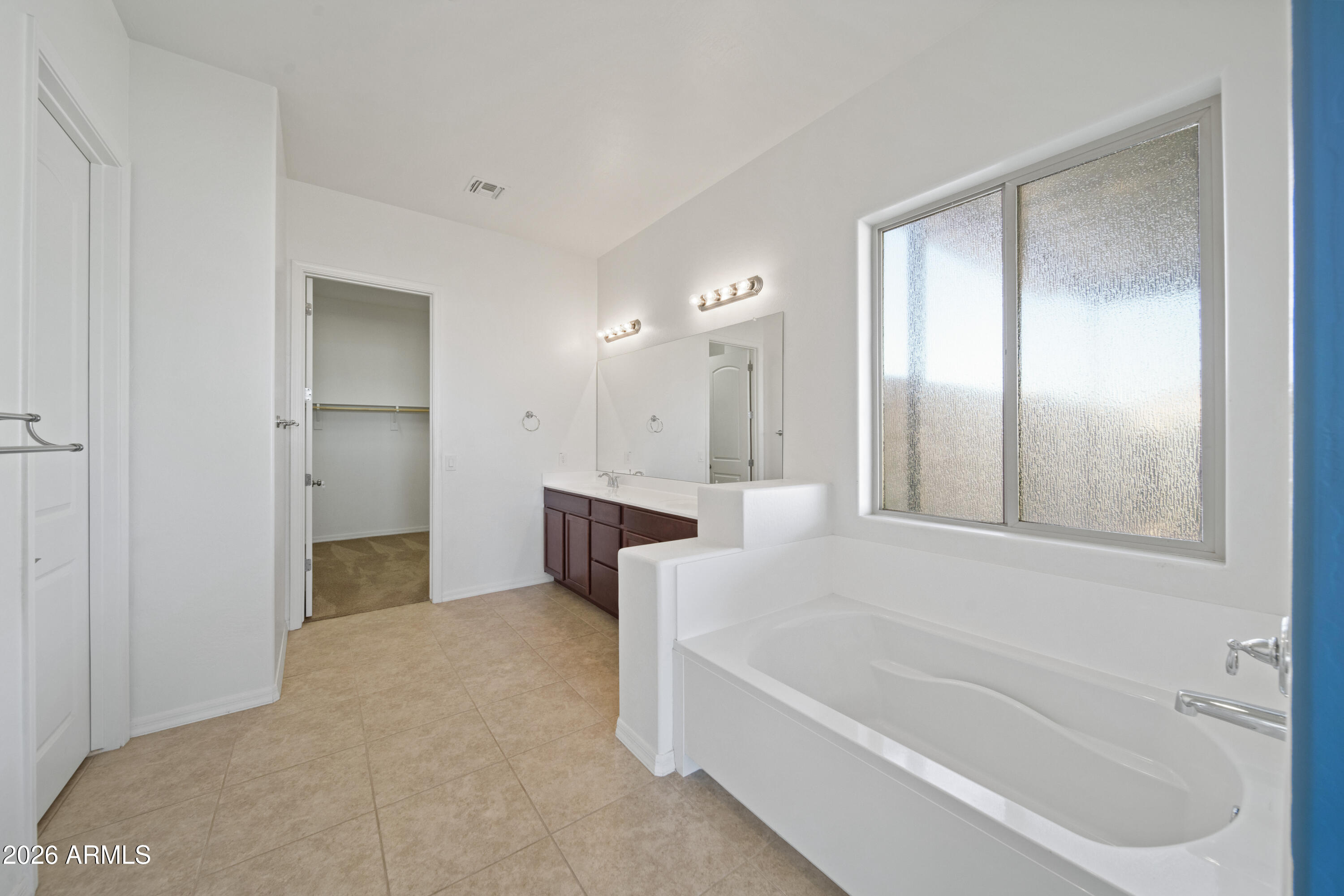 28621 North Bush Street Wittmann, AZ 85361 - Photo 31 of 41 a bathroom with a bathtub and a shower