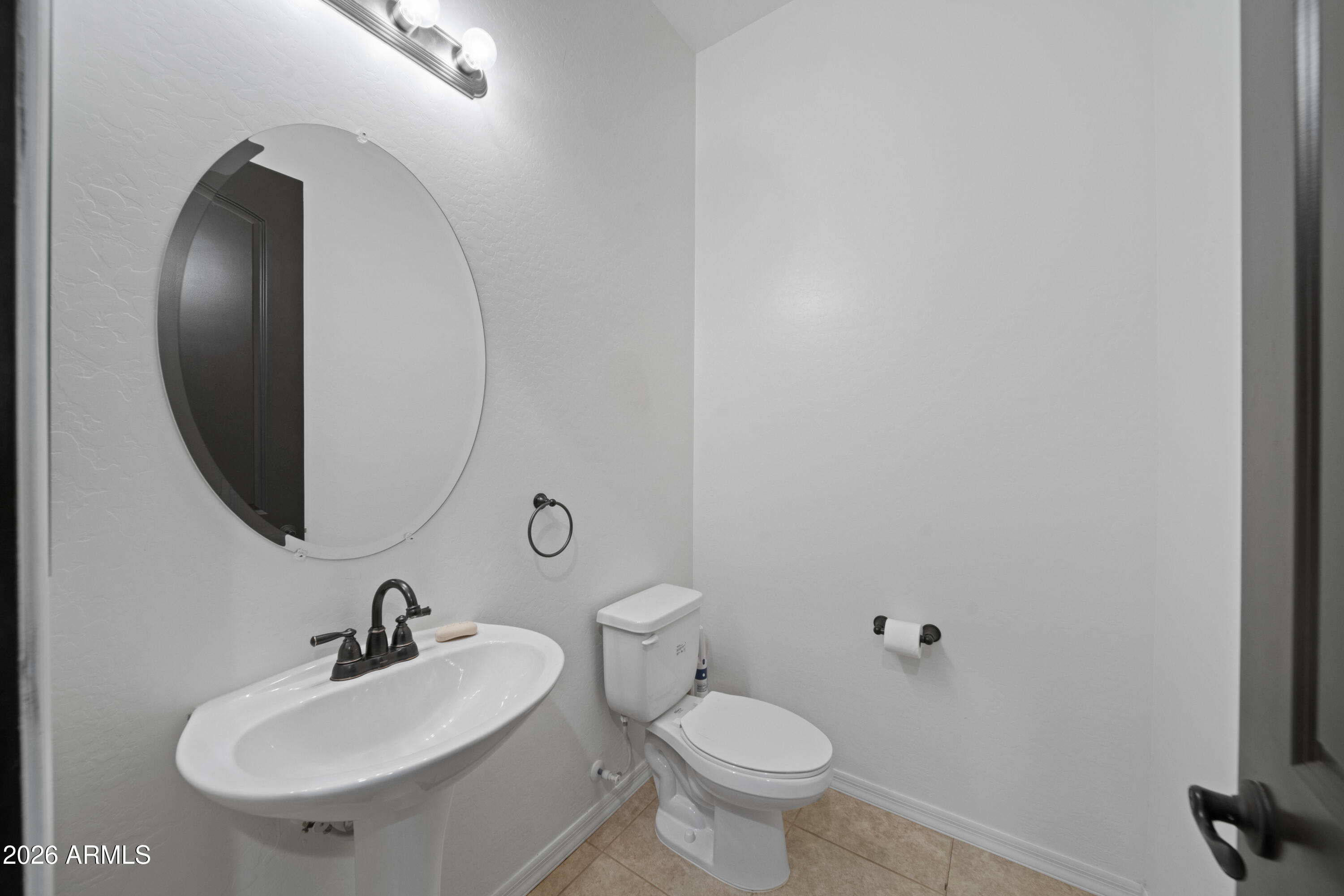 28621 North Bush Street Wittmann, AZ 85361 - Photo 36 of 41 a bathroom with a sink and a mirror
