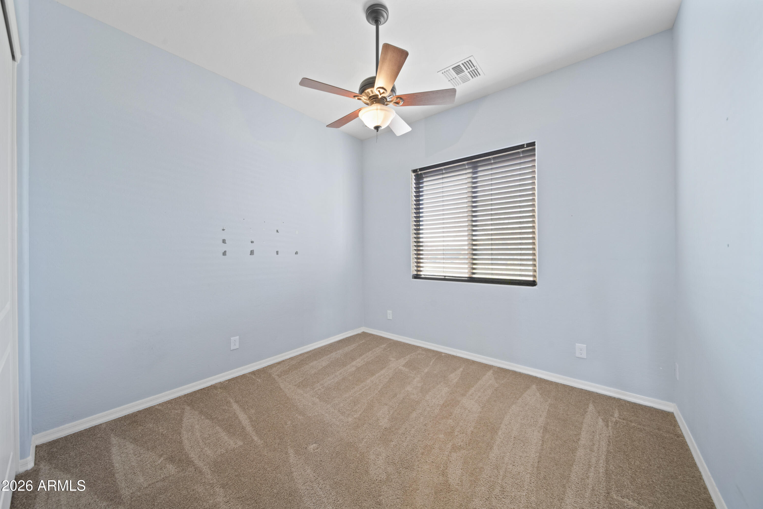 28621 North Bush Street Wittmann, AZ 85361 - Photo 39 of 41 wooden floor in an empty room with a window