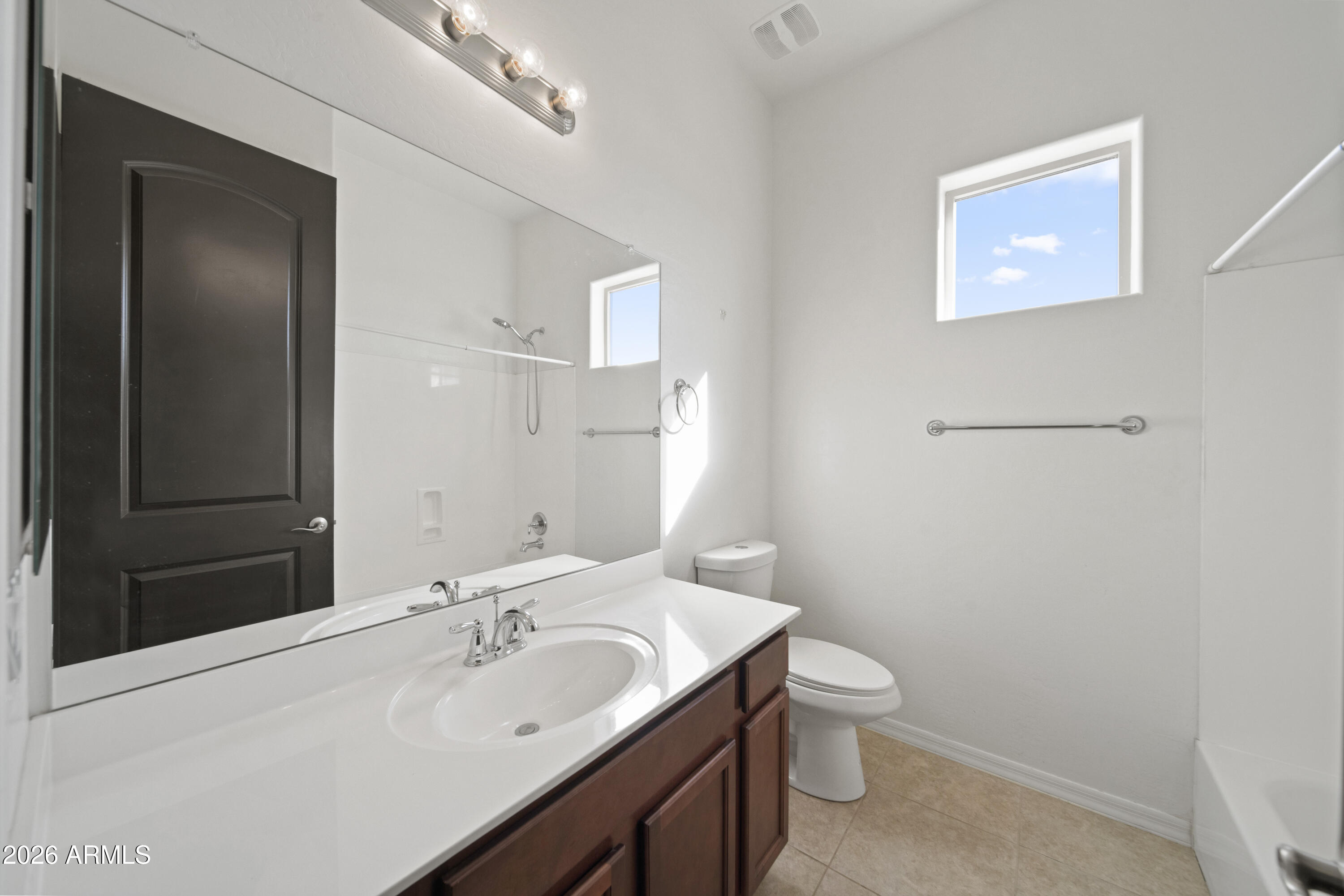 28621 North Bush Street Wittmann, AZ 85361 - Photo 40 of 41 a bathroom with a granite countertop sink a toilet and a mirror