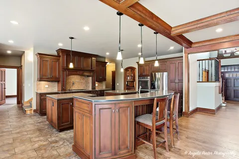 a kitchen with stainless steel appliances granite countertop a stove and a microwave