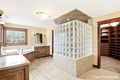 a bathroom with a tub a sink and a window