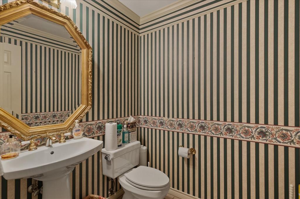 9 Willow Ridge Road Greenville, TX 75402 - Photo 13 of 31 Half bath featuring wallpapered walls and crown molding