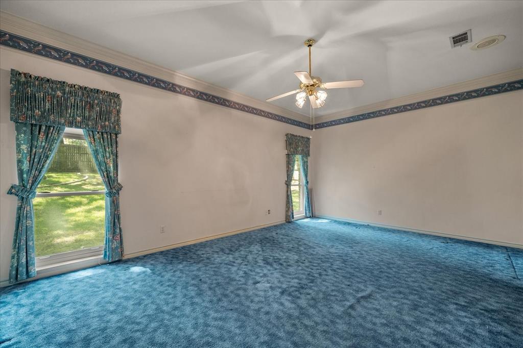 9 Willow Ridge Road Greenville, TX 75402 - Photo 14 of 31 Unfurnished room featuring ornamental molding, carpet floors, and a ceiling fan