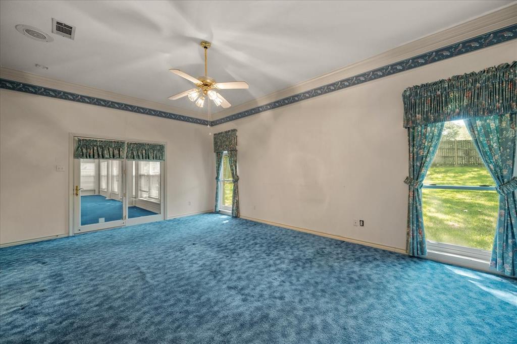 9 Willow Ridge Road Greenville, TX 75402 - Photo 15 of 31 Carpeted spare room featuring ornamental molding and a ceiling fan